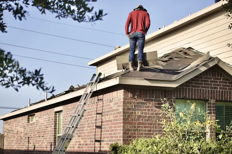 Professional roofer working on a residential roof in Leesylvania